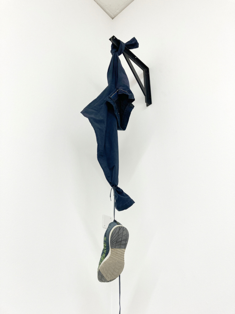 K-22.1 (Clothes hook), 2022 • steele angle, screws, trousers, shoe, 182 x 30 x 51 cm